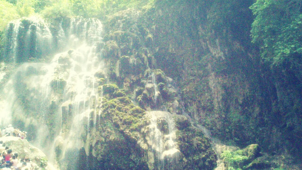 water, beauty in nature, nature, scenics, rock - object, high angle view, tranquility, motion, rock formation, tranquil scene, waterfall, idyllic, outdoors, day, no people, flowing water, sunlight, tree, non-urban scene, sea