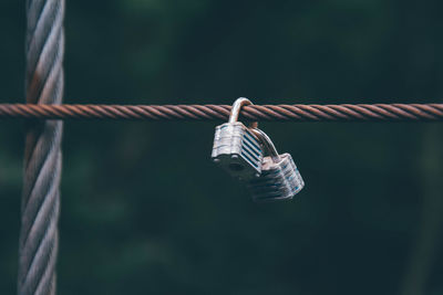 Close-up of rope tied to metal fence