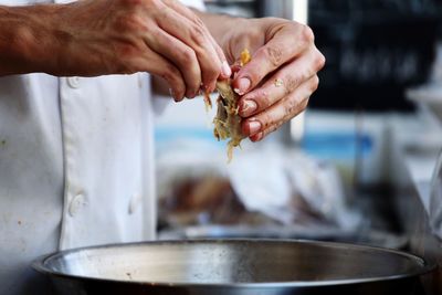 Close-up of cropped hand holding food