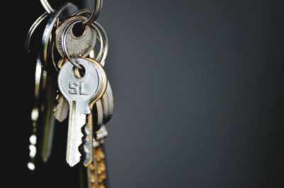 Close-up of keys hanging against wall