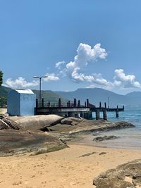 Scenic view of beach against sky in city