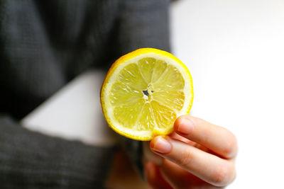 Close-up of hand holding lemon
