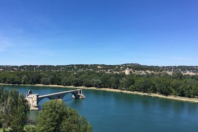 Scenic view of river against clear blue sky