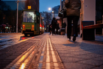 Tramway moving on street at dusk during foggy weather