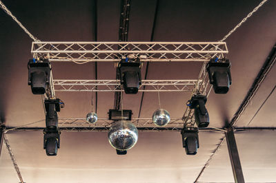 Low angle view of illuminated lights hanging from ceiling