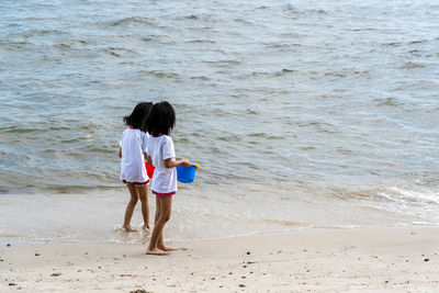 Rear view of women on beach