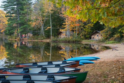 Boats moored in lake during autumn