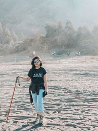 Full length of young woman standing on land