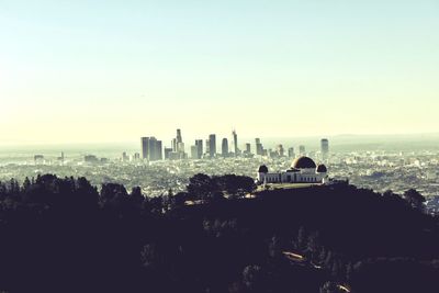 Buildings in city against clear sky