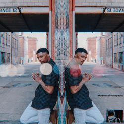 Full length of young man standing in city