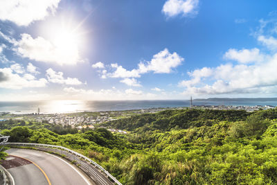 Scenic view of road by sea against sky