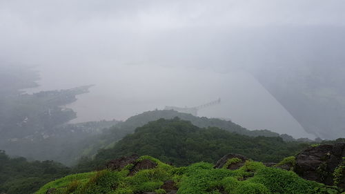 Scenic view of mountains against sky during rainy season