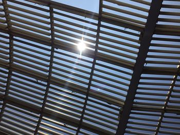 Low angle view of illuminated lighting equipment against sky