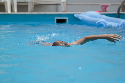 Boy swimming in pool