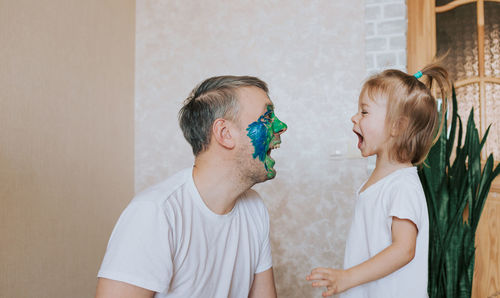 Children against wall at home