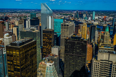 Aerial view of modern buildings in city against sky