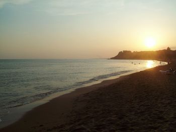 Scenic view of beach against sky during sunset