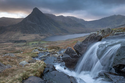 Scenic view of waterfall against mountain