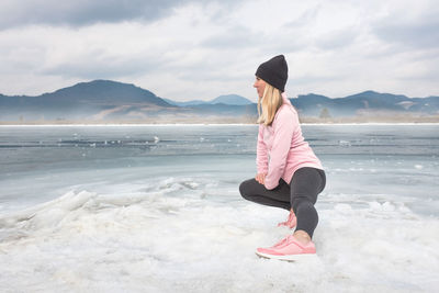 Rear view of woman standing on snow covered landscape