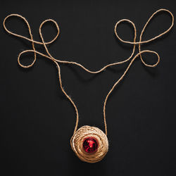 Close-up of heart shape decoration on table against black background