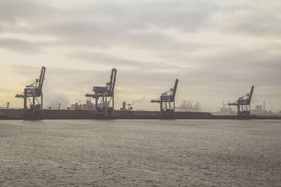 View of harbor against cloudy sky