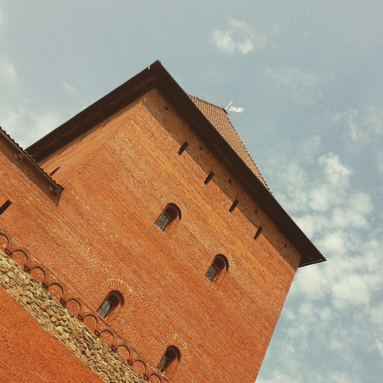 architecture, building exterior, built structure, low angle view, sky, cloud - sky, history, cloud, old, day, outdoors, roof, house, sunlight, no people, brick wall, wall - building feature, building, stone wall, residential structure