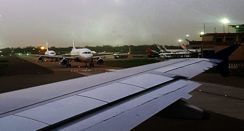 Airplane on runway against sky