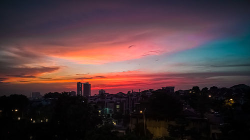 Silhouette buildings against sky during sunset