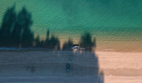 High angle view of boats moored on beach by sea