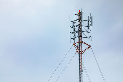 Low angle view of transmission tower against sky