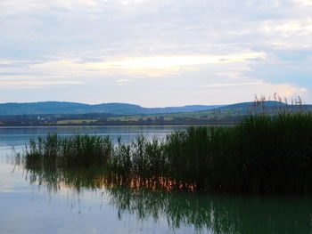 Scenic view of lake against sky during sunset