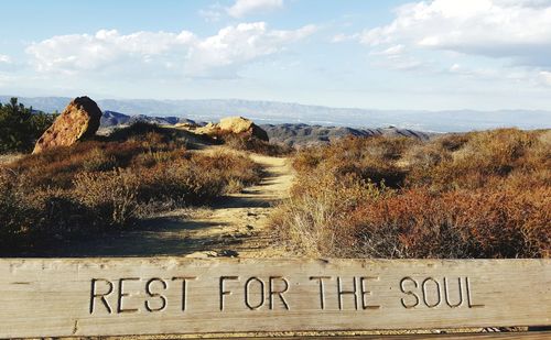 Text on land against sky