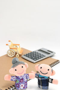 Close-up of toys on table against white background