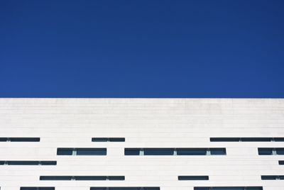 Low angle view of building against clear blue sky