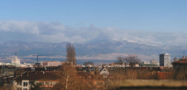 View of townscape and mountains against sky