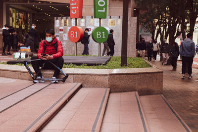 People on footpath in city