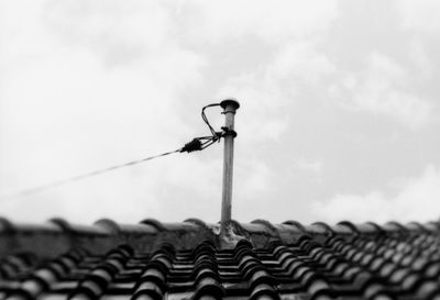 Low angle view of barbed wire on roof of building