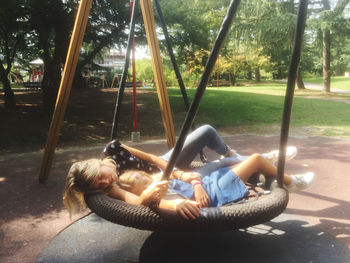 Rear view of woman on swing in park