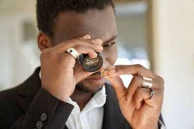 Side view of young man smoking cigarette