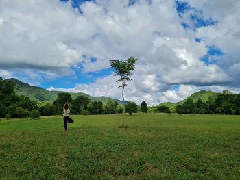 Man standing on field against sky