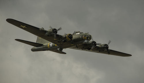 Low angle view of fighter plane flying against sky