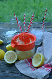 Close-up of lemon and squeezer on table