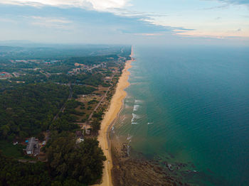 High angle view of city by sea against sky