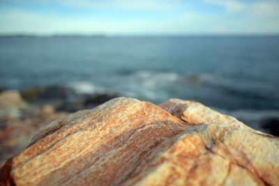 Close-up of rocks on beach against sky