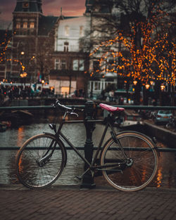 Bicycles parked on street by buildings in city