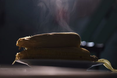 Close-up of bread on table against black background