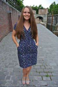 Portrait of smiling young woman standing outdoors