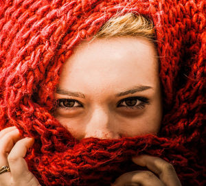 Full frame portrait of woman wearing red headscarf