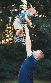 Side view of father and boy on land