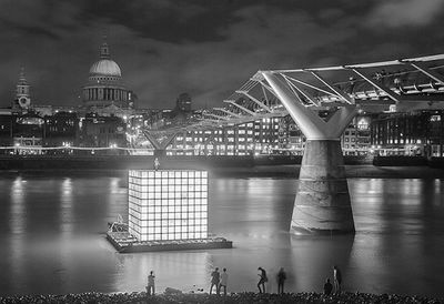 View of illuminated bridge over river at night